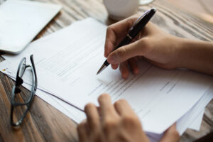 businessman examining papers table - DomiDocs