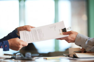 closeup hands passing contract unrecognizable businessman - DomiDocs